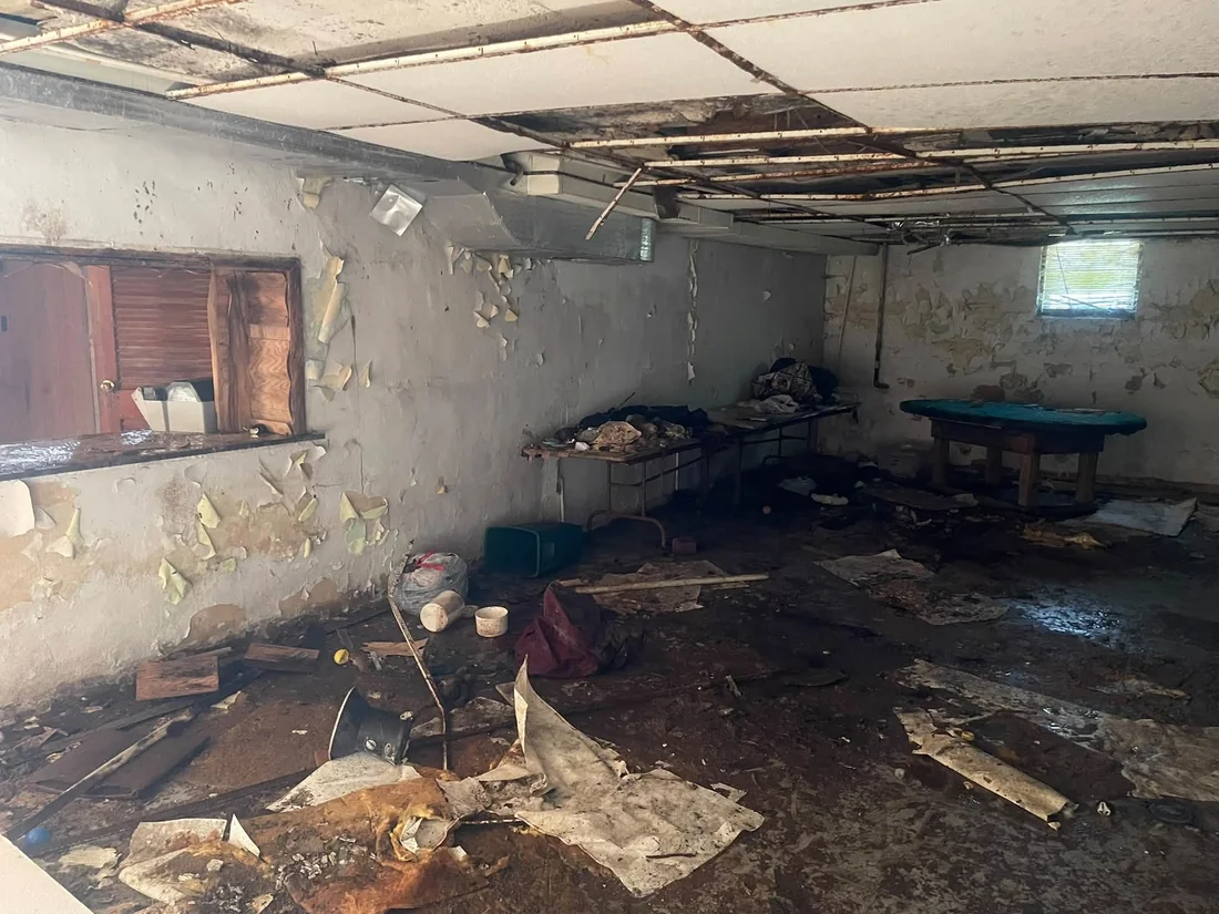 Interior cleanout with furniture and loose debris before clearing